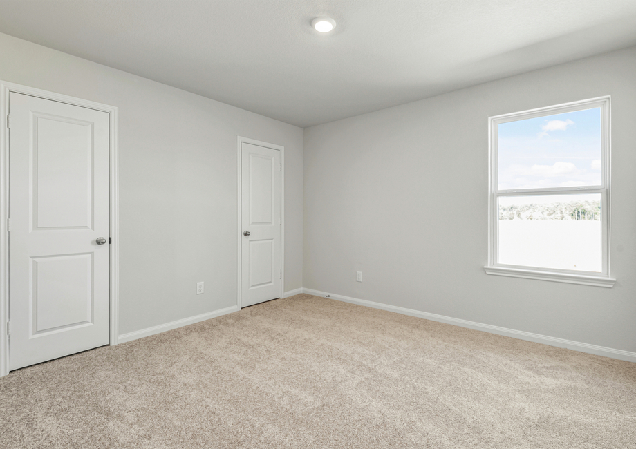 A secondary bedroom with two closets