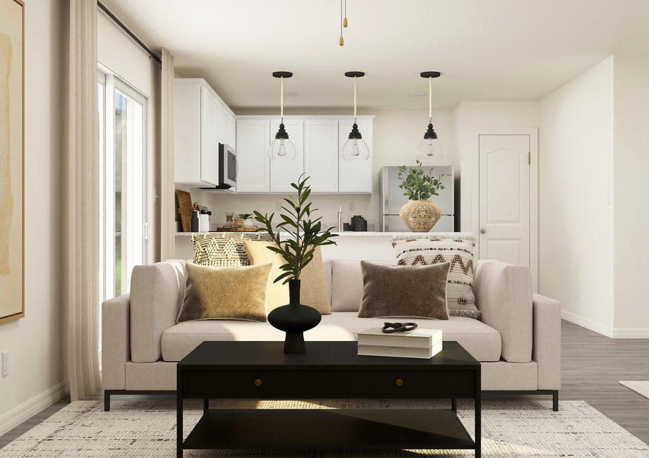 Rendering of the
  living room furnished with a white couch. The kitchen can be seen behind the
  couch.