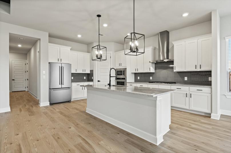 Enjoy an oversized island with black pendant lights.