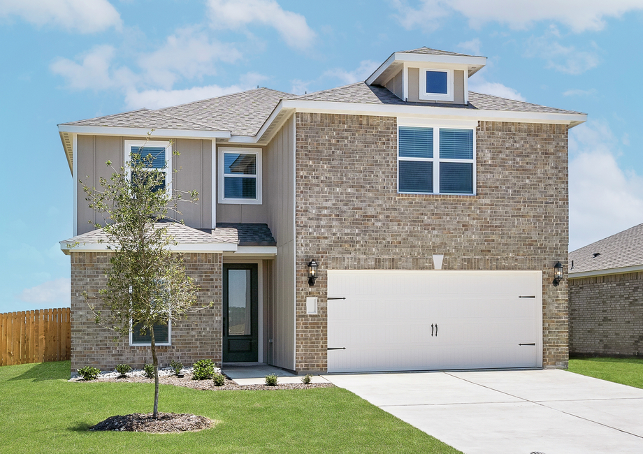 The two-story Driftwood plan has a gorgeous brick exterior with siding detail.