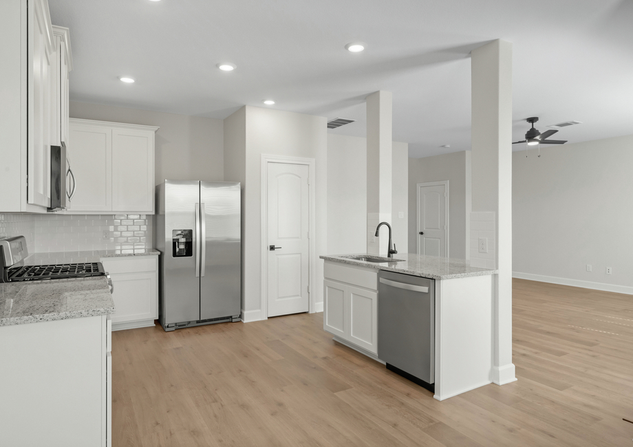 The kitchen looks out to the family room.