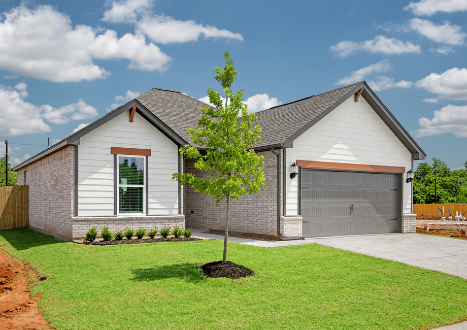 The Arcadia is a beautiful one story home with a brick and siding exterior with wood details.