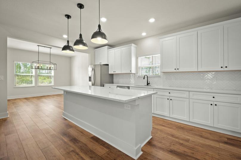 An oversized quartz island is located in the kitchen.
