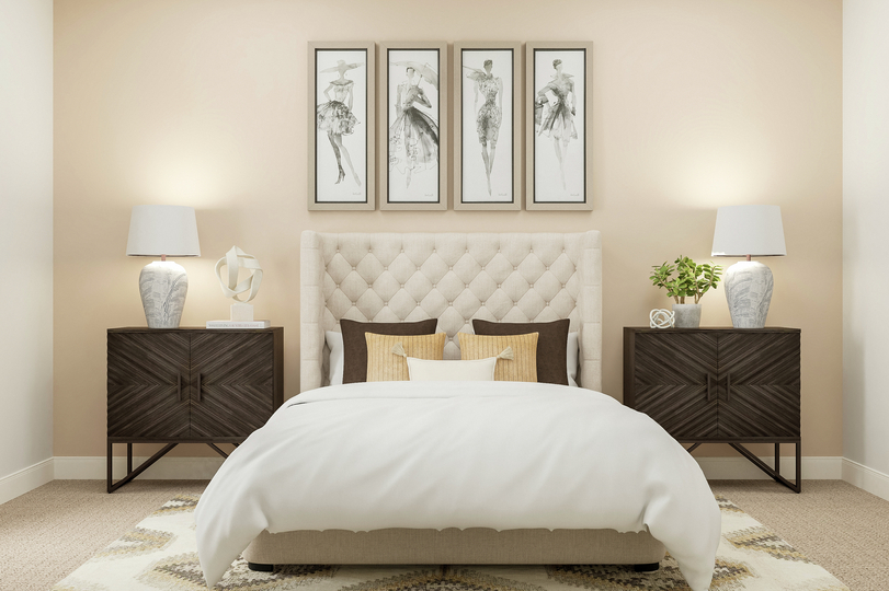 Rendering of a bedroom with an inviting
  cream-colored bed alongside two modern nightstands. The peach accent wall
  houses four paintings that complete the space.