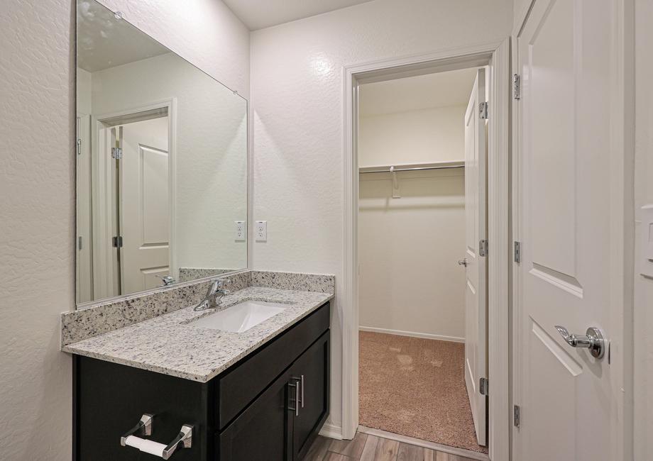 Here is the bathroom with an attached walk-in closet.