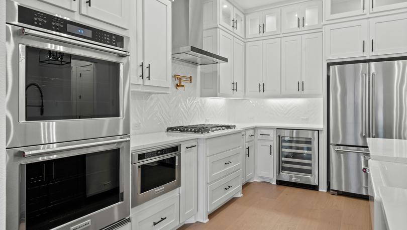 The kitchen has stainless-steel KitchenAid appliances.