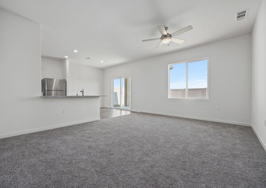 The family room is spacious with a ceiling fan.