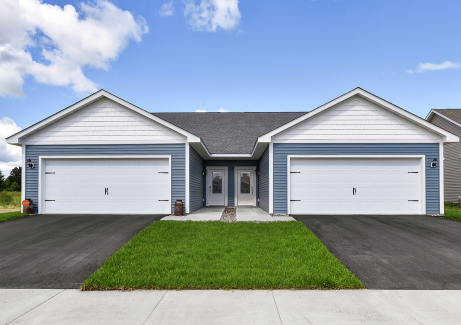 The Oak is a beautiful home with siding and a two car garage.