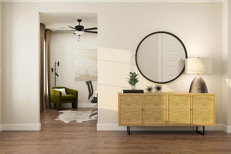 Renderings of foyer that is furnished
  with wall dÃ©cor and a table.