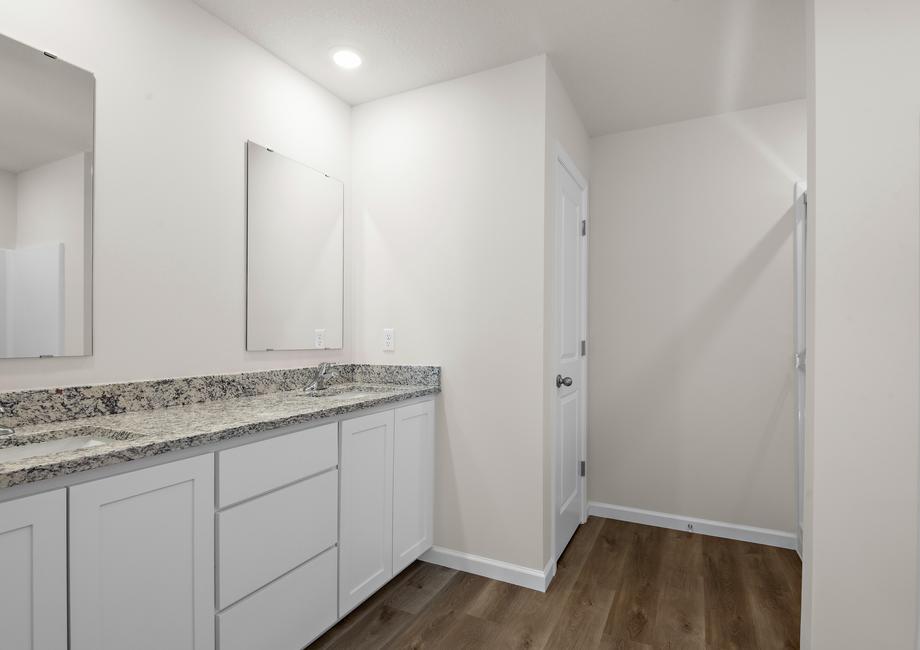 The master bathroom has a dual sink vanity.