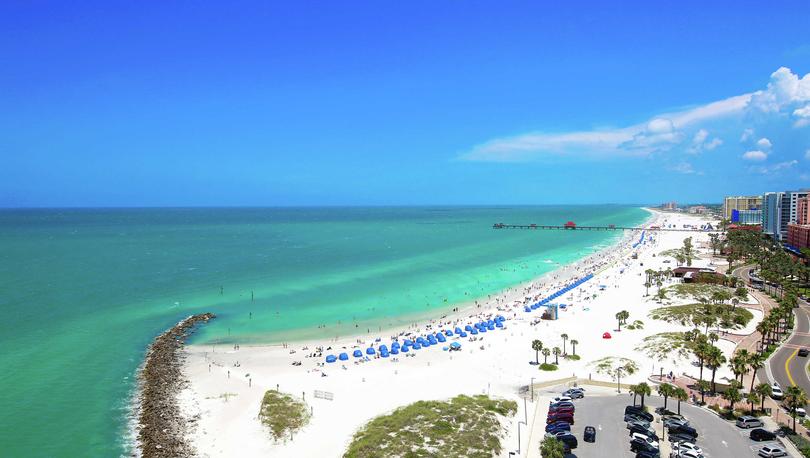 Tampa, Florida Clearwater Beach with white sands, green water, and blue sky