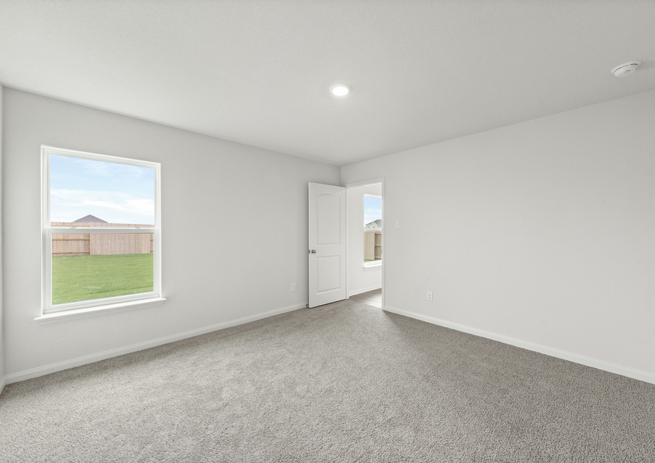 The master bedroom of the Rio Grande has a large window that lets in great natural light and backyard views.