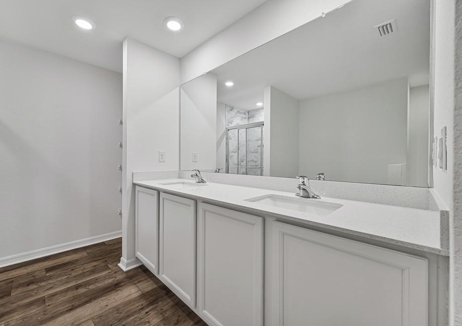 The master bathroom has a spacious two sink vanity, linen closet, walk-in shower, and a tub