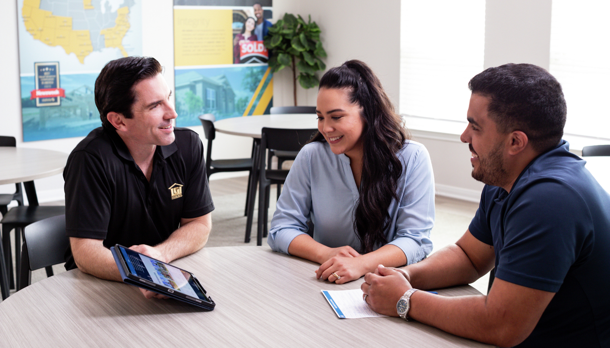 LGI Homes New Home Consultant shares information with couple buying a new home.