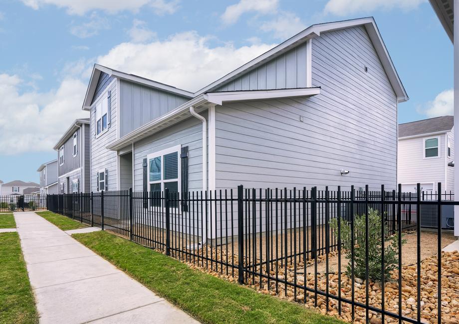 Angled exterior of the Davis plan with a wrought iron fence.
