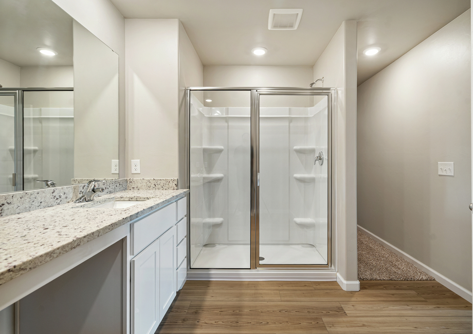 The master bath features a glass-enclosed shower.