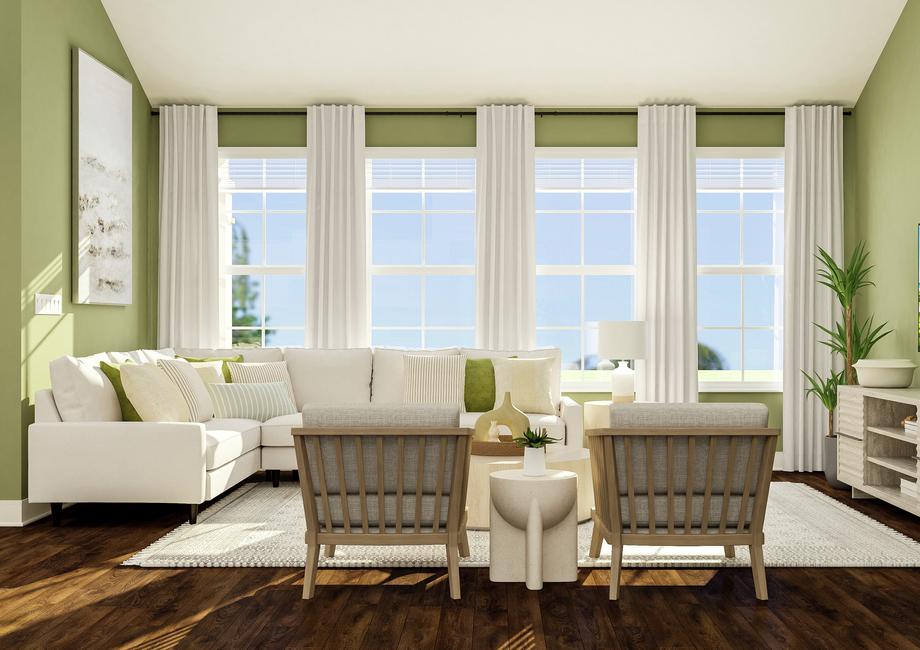 Rendering of living room area showing a
  white sectional couch along a green accent wall and large windows, a coffee
  table and accent chairs, and a media cabinet with tv on the right with dark
  wood look flooring throughout.