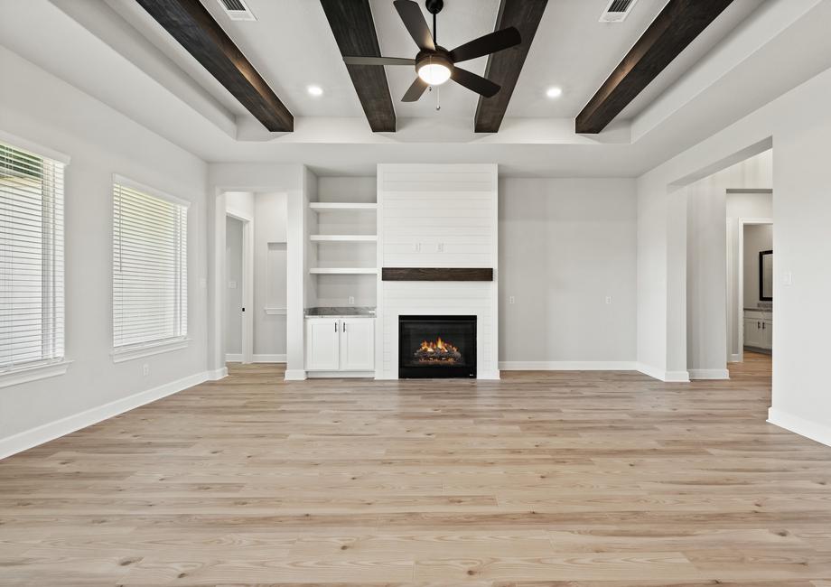 A stately fireplace includes shiplap detailing.