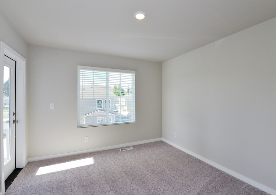 The master bedroom is spacious with a large window and access to the deck.