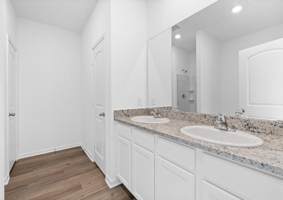 The master bathroom features a dual sink vanity.