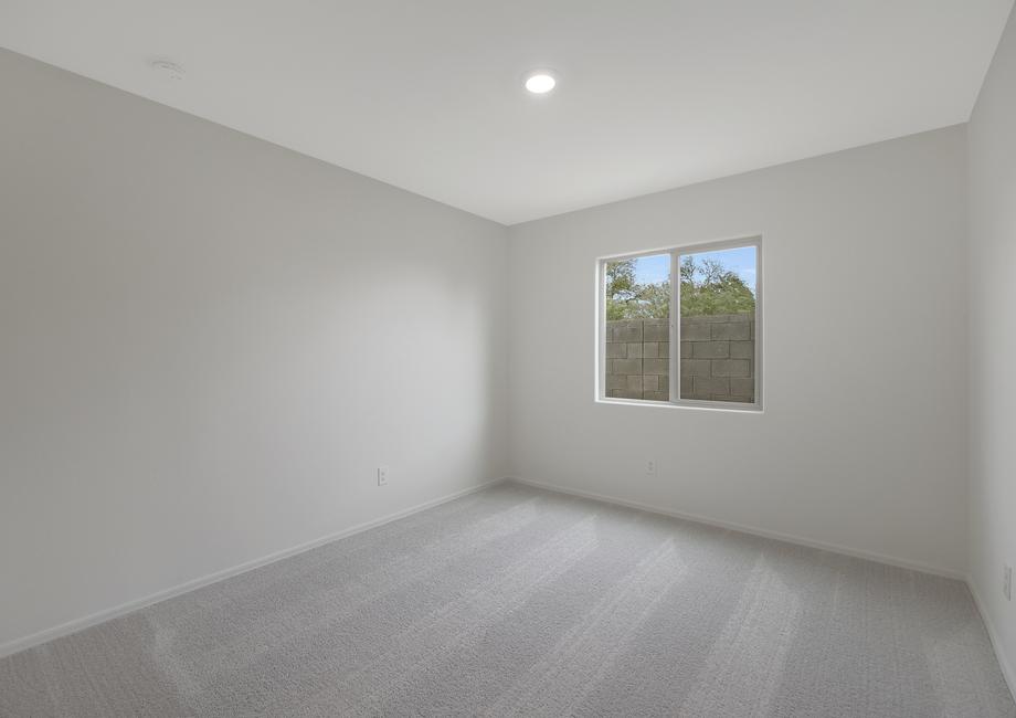 Secondary bedroom with windows and recessed lighting.