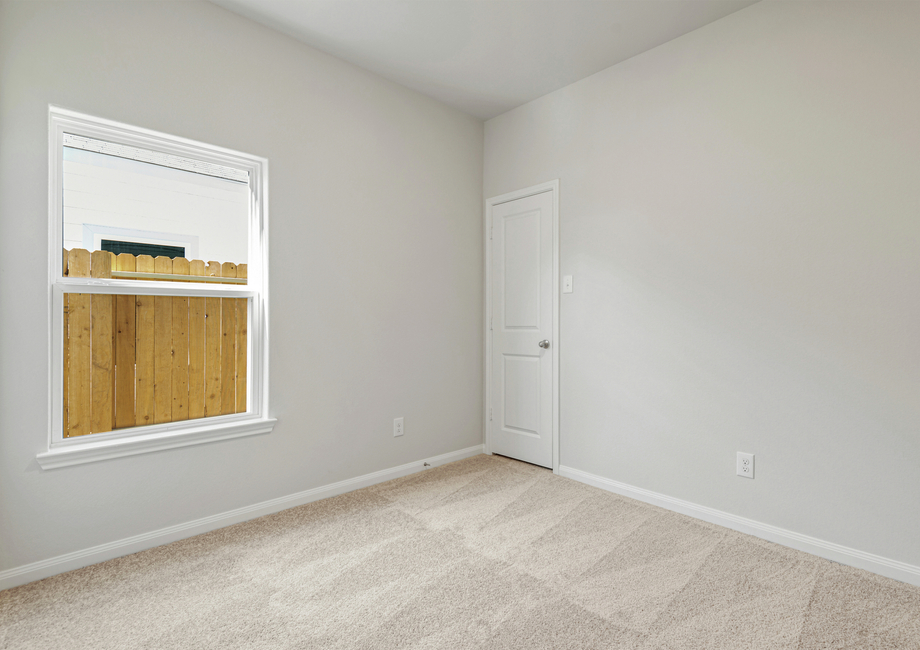 Secondary bedroom with a closet and lush carpet