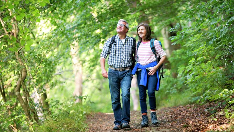 Middle-aged couple hiking. 