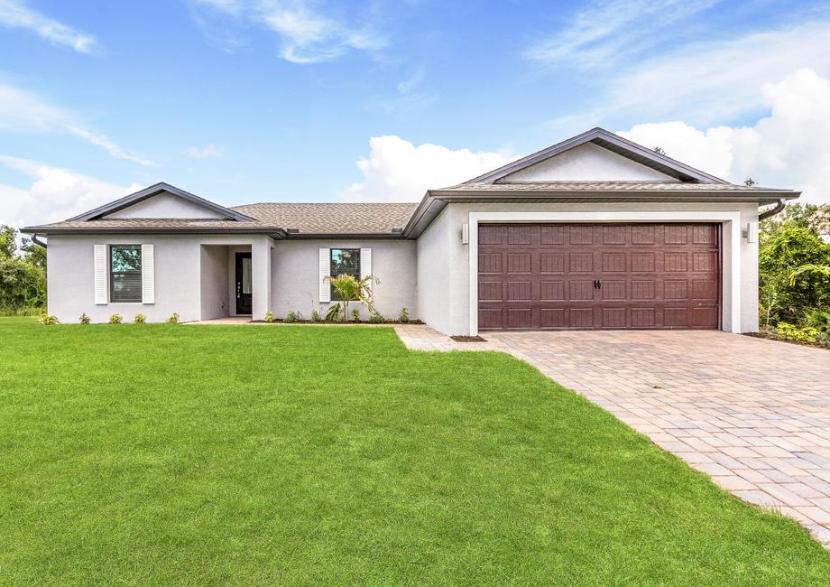 A beautiful one story house with shutters and a two-car garage.