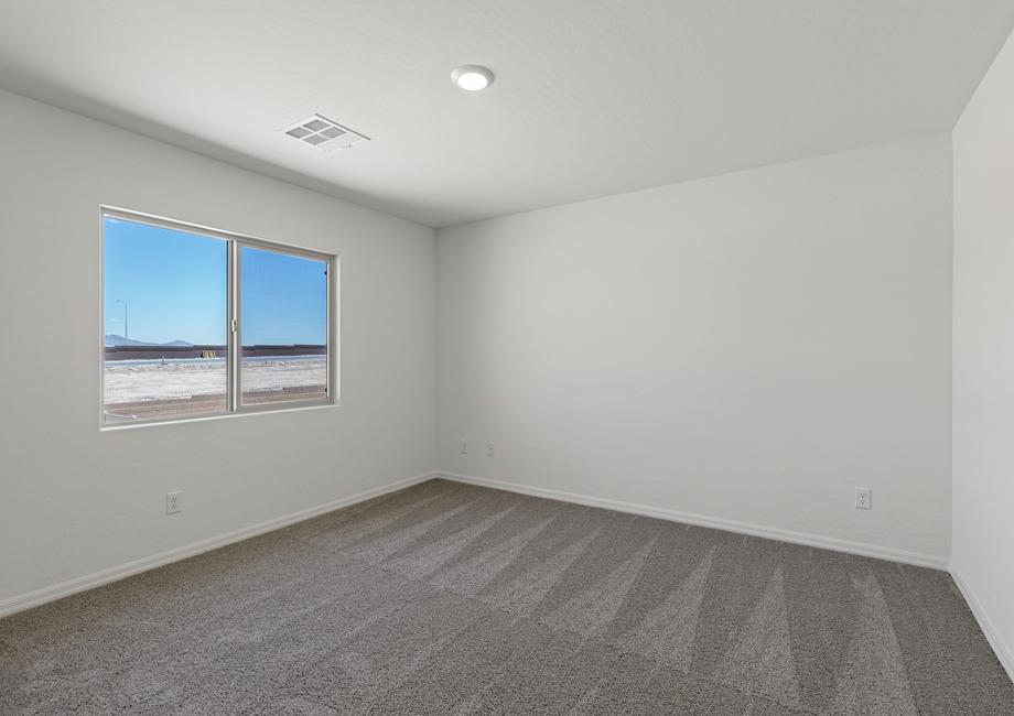 The master bedroom has carpet and a large window.