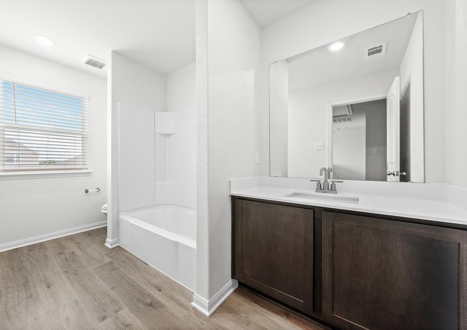 The secondary bathroom of the Cypress has a large vanity and shower-tub combo.