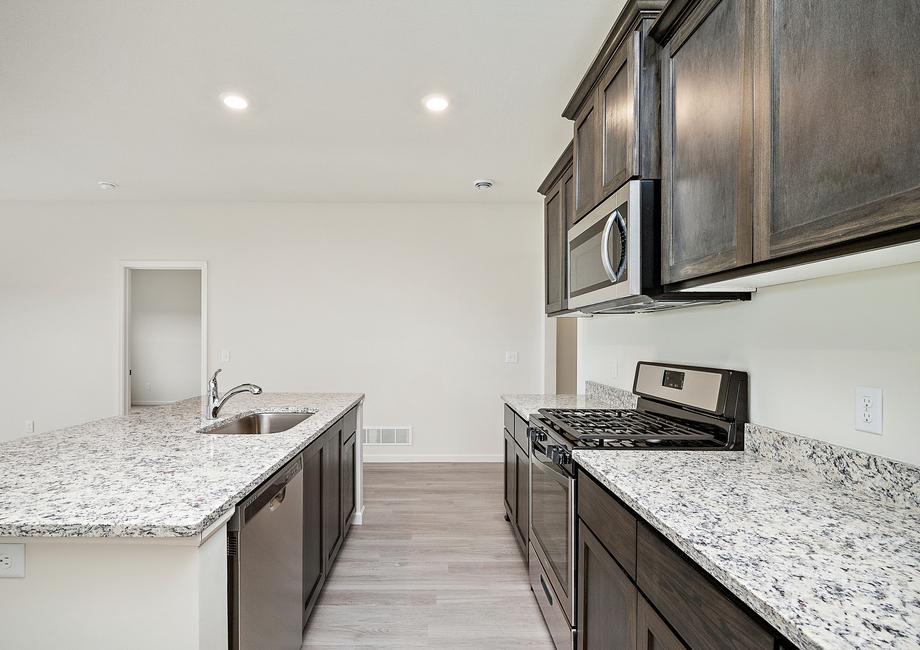 The kitchen is chef-ready with stainless steel appliances