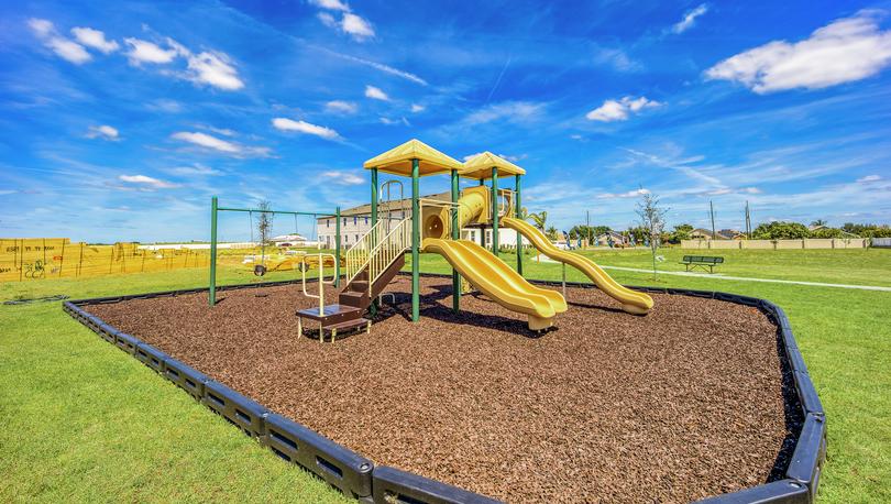 A playground at Sol Vista with slides and a swing set