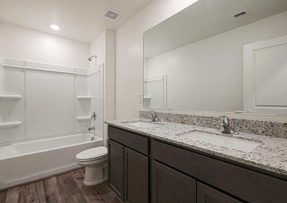 This bathroom has a spacious vanity with two sinks.