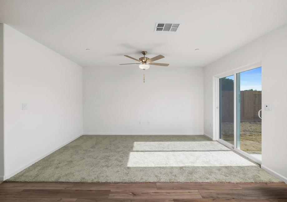 The family room is spacious with a ceiling fan.