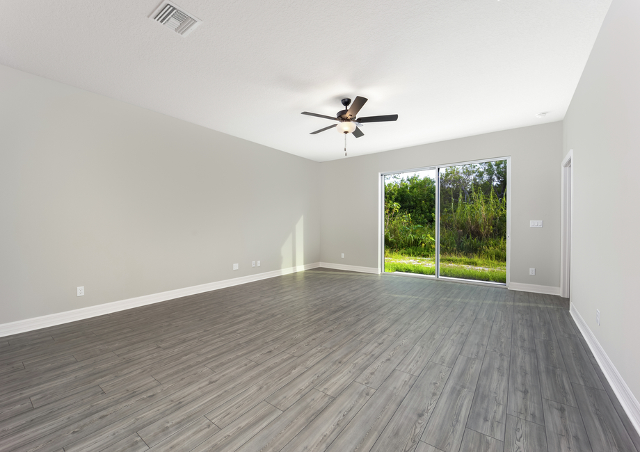 The family room has sliding glass doors that open into the backyard