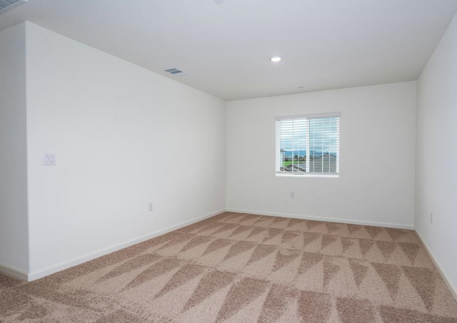 The master bedroom is spacious with a large window.