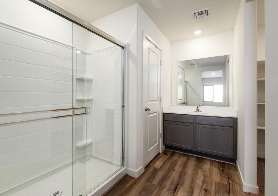This bathroom has spacious countertops and a glass-enclosed shower.
