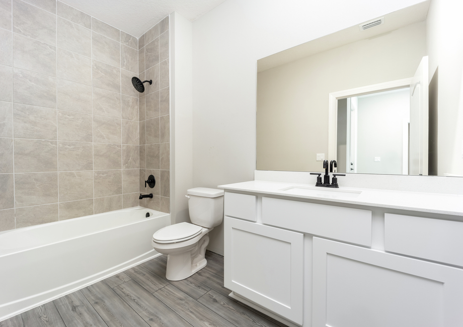 The spare bathroom has a large vanity that is ready for all of your guests