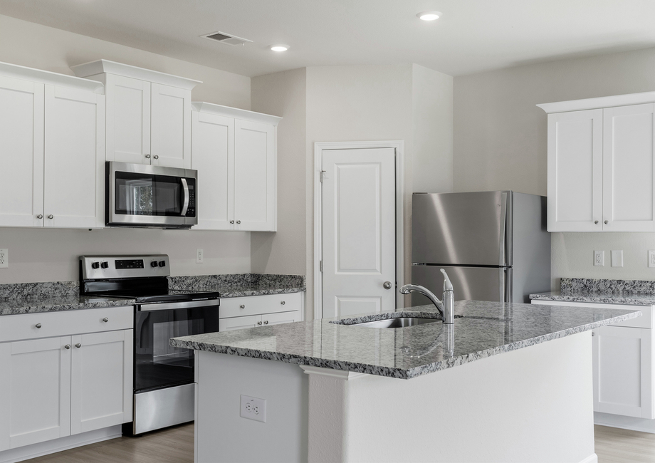 The kitchen comes with granite countertops and stainless steel appliances.