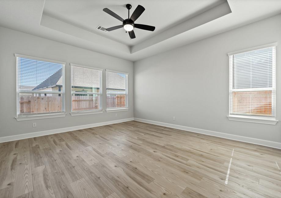 The master bedroom has plenty of natural light thanks to multiple large windows.