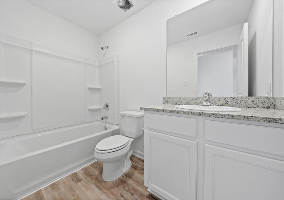 The secondary bathroom with plenty of storage space
