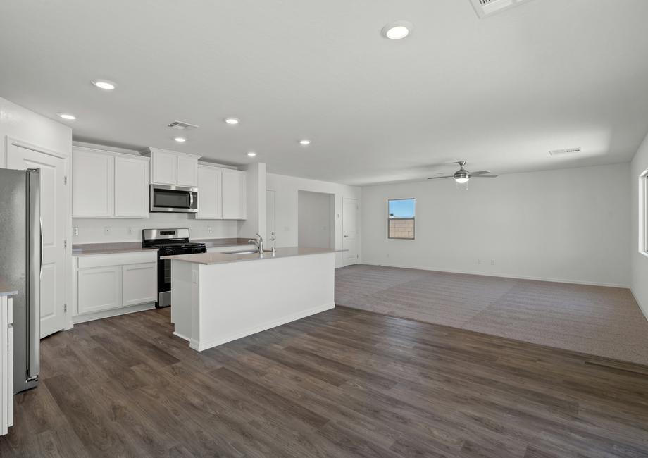 The open layout shows the kitchen open to the dining room and the family room.