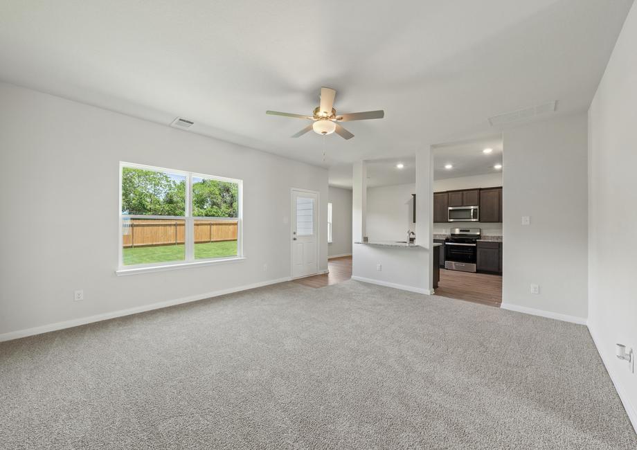 The family room of the Colorado plan has a large window that lets in great, natural light.