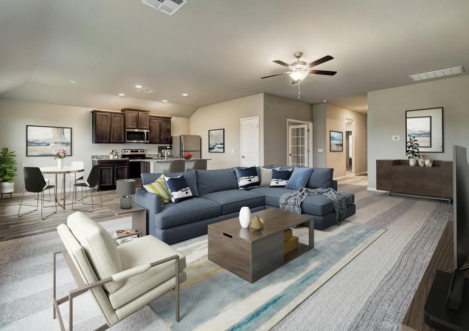 Staged living room with a blue coach and tan chair.