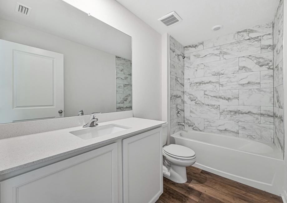 The spare bathroom has a large vanity area ready for your guests to get ready