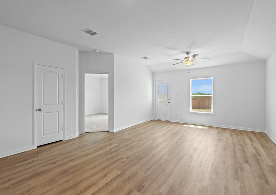 Family room with a beautiful window and door to the backyard