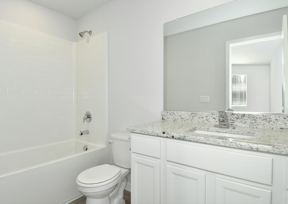 The secondary bathroom has a tub shower combo.