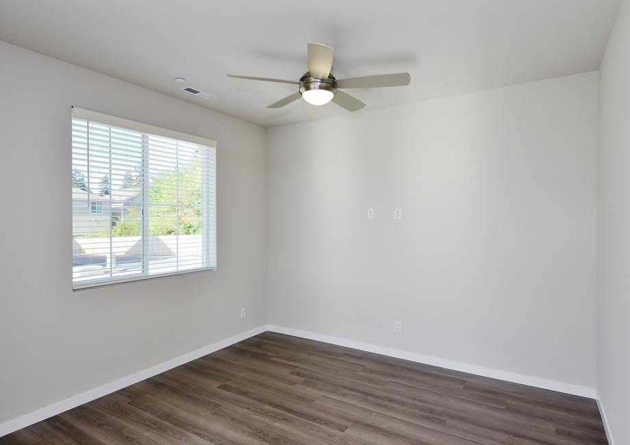 The family room is spacious with a ceiling fan.