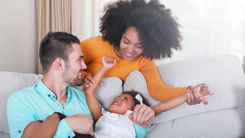 Stock photo of a playful young family at home. Family, Domestic Life, Happiness, Sofa, House.