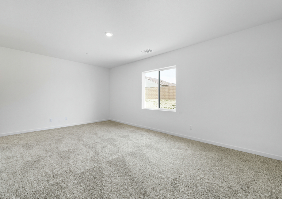 The master bedroom is incredibly spacious and has a window.